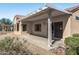 Covered patio with seating area, offering a relaxing outdoor space at 15113 W Cactus Ridge Way, Surprise, AZ 85374