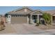 Single-story home with a two-car garage and landscaped front yard at 15282 W Mckinley St, Goodyear, AZ 85338