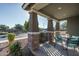 Front porch with small seating area and brick columns at 15282 W Mckinley St, Goodyear, AZ 85338