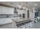 Modern kitchen with white cabinets, granite island, and stainless steel appliances at 15282 W Mckinley St, Goodyear, AZ 85338