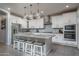Spacious kitchen with white cabinets, granite countertops, and an island at 15282 W Mckinley St, Goodyear, AZ 85338