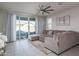 Living room with sectional sofa and sliding glass door to patio at 15282 W Mckinley St, Goodyear, AZ 85338