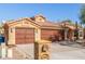 Front view of a house with a three-car garage and stone pillars at 15708 E Chicory Dr, Fountain Hills, AZ 85268