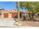 House exterior with desert landscaping and three-car garage at 15708 E Chicory Dr, Fountain Hills, AZ 85268