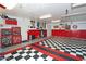 Spacious garage with red and black checkered floor, ample storage, and room for vehicles at 15708 E Chicory Dr, Fountain Hills, AZ 85268