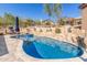 Inviting kidney-shaped pool surrounded by rocks and patio seating at 15708 E Chicory Dr, Fountain Hills, AZ 85268