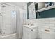 Updated bathroom with subway tile, white vanity, and a shower/tub combo at 1614 W Lynwood St, Phoenix, AZ 85007