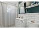Updated bathroom with subway tile, white vanity, and a shower/tub combo at 1614 W Lynwood St, Phoenix, AZ 85007