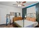 Cozy bedroom with an antique metal bed frame and a dark green accent wall at 1614 W Lynwood St, Phoenix, AZ 85007