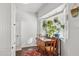 Bright dining area with wooden table and bay window, filled with plants at 1614 W Lynwood St, Phoenix, AZ 85007
