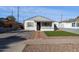 Front yard view of a renovated home with brick driveway at 1614 W Lynwood St, Phoenix, AZ 85007