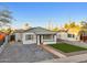 Cute bungalow with a charming front porch and well-manicured lawn at 1614 W Lynwood St, Phoenix, AZ 85007
