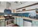 Modern kitchen with teal tile backsplash and stainless steel appliances at 1614 W Lynwood St, Phoenix, AZ 85007