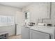 Laundry room with Samsung washer and dryer and extra storage at 1614 W Lynwood St, Phoenix, AZ 85007