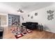 Living room with hardwood floors, a black couch, and a coffee table at 1701 W Tuckey Ln # 218, Phoenix, AZ 85015