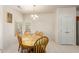 Bright dining room features a wood table with chairs and access to kitchen at 17311 N Havasupai Dr, Surprise, AZ 85374