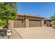 House exterior featuring a three-car garage and mature trees at 17311 N Havasupai Dr, Surprise, AZ 85374