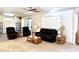 Living room with leather sofas, and ceiling fans at 17311 N Havasupai Dr, Surprise, AZ 85374