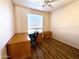 Bright home office features a wood desk and chair at 17311 N Havasupai Dr, Surprise, AZ 85374