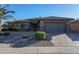 Single-story home with stone accents and landscaped front yard at 17901 W Tierra Del Sol Dr, Surprise, AZ 85387