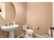 Small bathroom with pedestal sink and toilet at 1819 W Magdalena Ln, Phoenix, AZ 85041