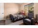 Bedroom with a full-size bed and a recliner at 1819 W Magdalena Ln, Phoenix, AZ 85041