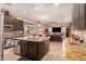 Open kitchen with granite countertops, dark cabinetry, and an island at 1819 W Magdalena Ln, Phoenix, AZ 85041