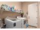Laundry room with washer, dryer, and ample storage shelving at 1819 W Magdalena Ln, Phoenix, AZ 85041