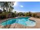 Inviting kidney-shaped pool surrounded by a landscaped backyard at 1819 W Magdalena Ln, Phoenix, AZ 85041