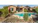 Lovely kidney-shaped pool and patio with lush landscaping at 1819 W Magdalena Ln, Phoenix, AZ 85041