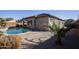 Inviting kidney-shaped pool with surrounding patio and landscaping at 20226 N 260Th Dr, Buckeye, AZ 85396