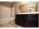 Bathroom with tub shower, toilet and dark brown vanity at 20226 N 260Th Dr, Buckeye, AZ 85396