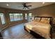 Spacious bedroom with pool view and wood-look floors at 20226 N 260Th Dr, Buckeye, AZ 85396