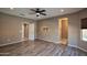 Bedroom with wood-look floors and access to bathroom at 20226 N 260Th Dr, Buckeye, AZ 85396