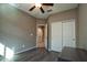 Bedroom with ceiling fan, double doors to closet and bath at 20226 N 260Th Dr, Buckeye, AZ 85396