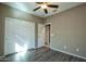 Bright bedroom with double door closet and ceiling fan at 20226 N 260Th Dr, Buckeye, AZ 85396