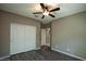 Bedroom featuring a ceiling fan and mirrored closet doors at 20226 N 260Th Dr, Buckeye, AZ 85396