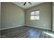 Spacious bedroom with wood-look flooring and ceiling fan at 20226 N 260Th Dr, Buckeye, AZ 85396
