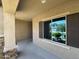 Covered entryway with sliding glass door and tiled flooring at 20226 N 260Th Dr, Buckeye, AZ 85396