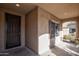 Inviting front porch with a dark brown door and security screen at 20226 N 260Th Dr, Buckeye, AZ 85396