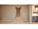 A view down a hallway with taupe colored walls and tile floors at 20226 N 260Th Dr, Buckeye, AZ 85396