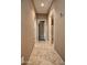 Bright hallway with tile flooring and access to bedrooms and bathrooms at 20226 N 260Th Dr, Buckeye, AZ 85396