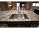 Kitchen island with granite countertop and stainless steel sink at 20226 N 260Th Dr, Buckeye, AZ 85396