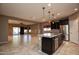 Kitchen with dark cabinets, granite counters and island at 20226 N 260Th Dr, Buckeye, AZ 85396