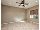Spacious living room with tile floors and ceiling fan at 20226 N 260Th Dr, Buckeye, AZ 85396