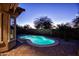 Lighted kidney-shaped pool at night in a desert setting at 20226 N 260Th Dr, Buckeye, AZ 85396