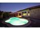 Relaxing lighted pool at night with surrounding patio at 20226 N 260Th Dr, Buckeye, AZ 85396