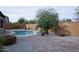Beautiful backyard with a refreshing pool surrounded by desert landscaping, brick accents, and a private courtyard feel at 20226 N 260Th Dr, Buckeye, AZ 85396