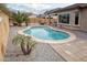 Private backyard features a refreshing pool, stone patio, desert landscaping, and a tranquil setting for relaxation and recreation at 20226 N 260Th Dr, Buckeye, AZ 85396