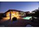 Attractive pool and patio area with exterior lighting at night at 20226 N 260Th Dr, Buckeye, AZ 85396